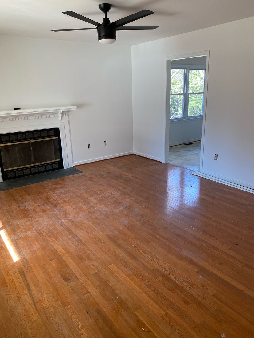 Freshly painted living room with white walls and trim by ProCoats Painting Plus