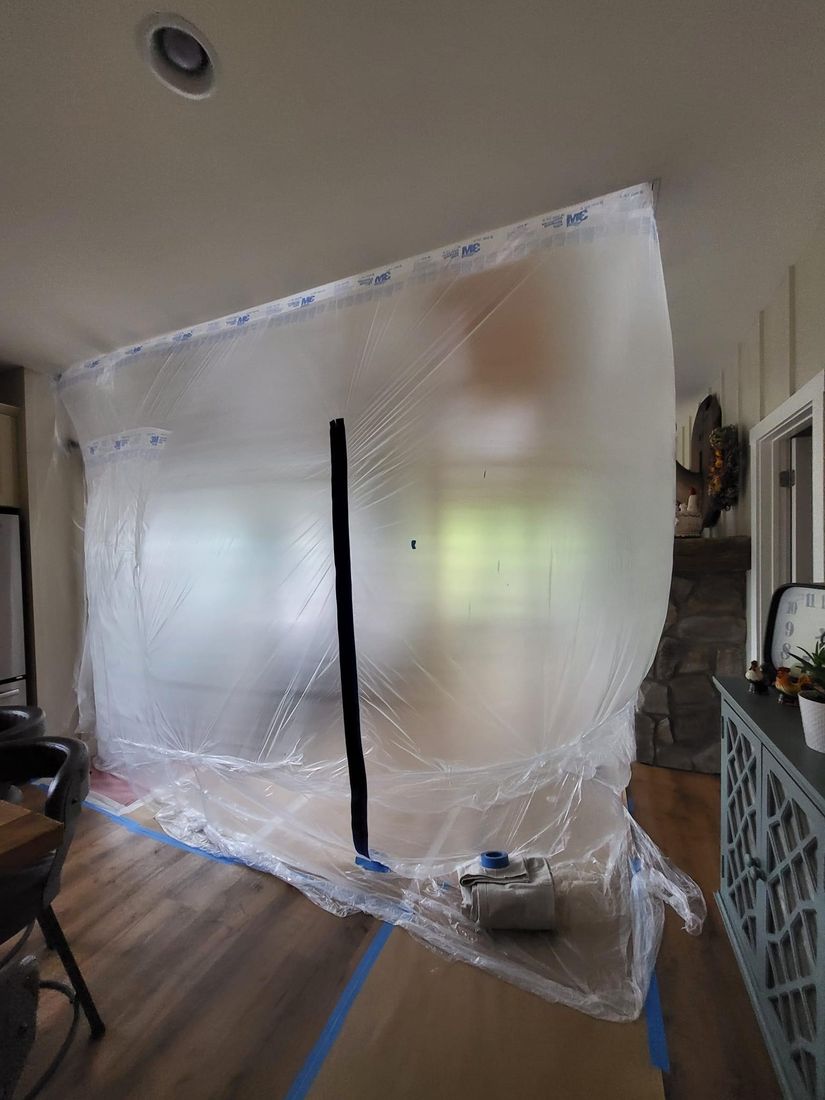 Plastic containment sheeting protecting a room during a ProCoats Painting Plus project